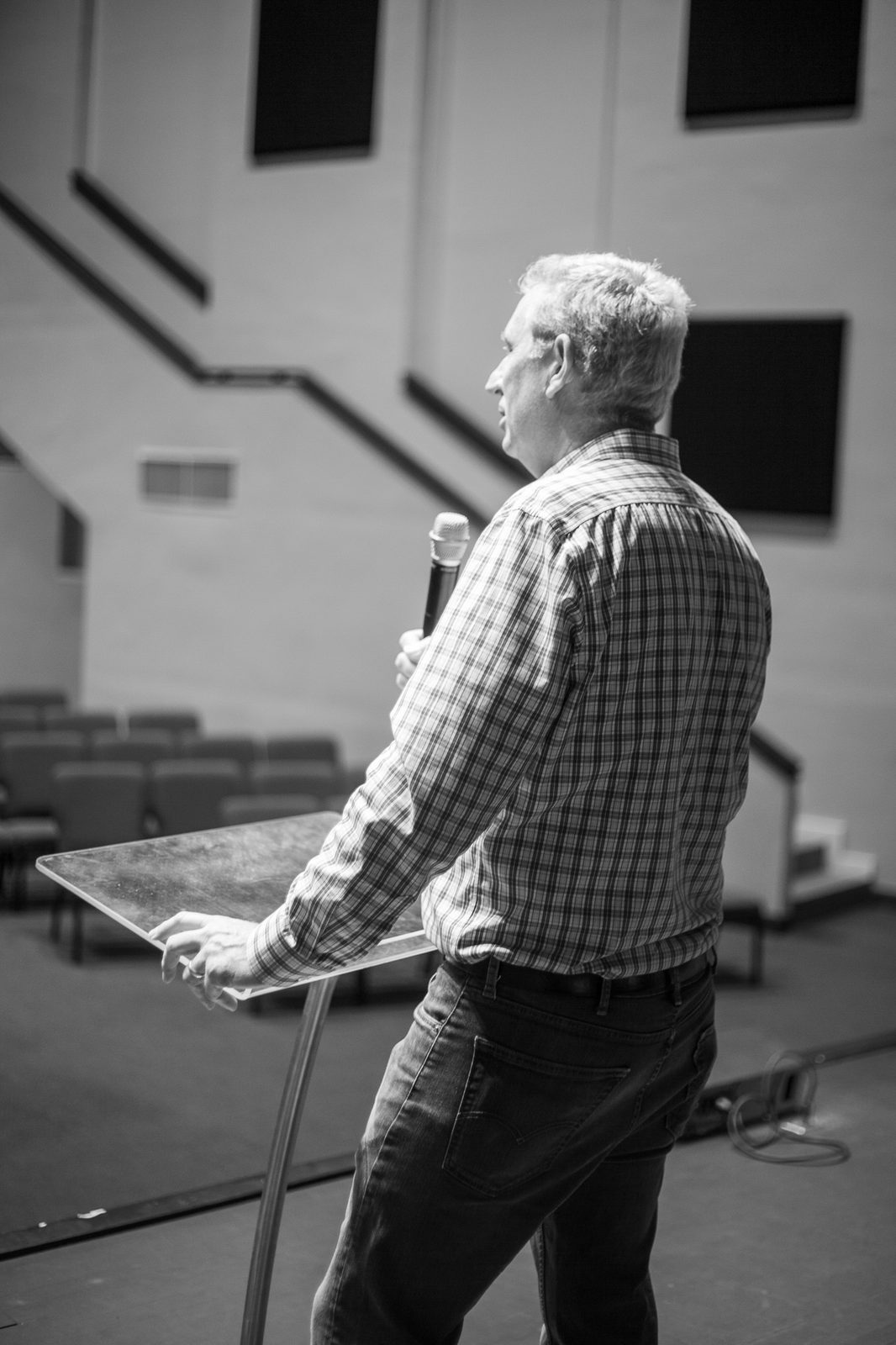 At the lectern, black and white